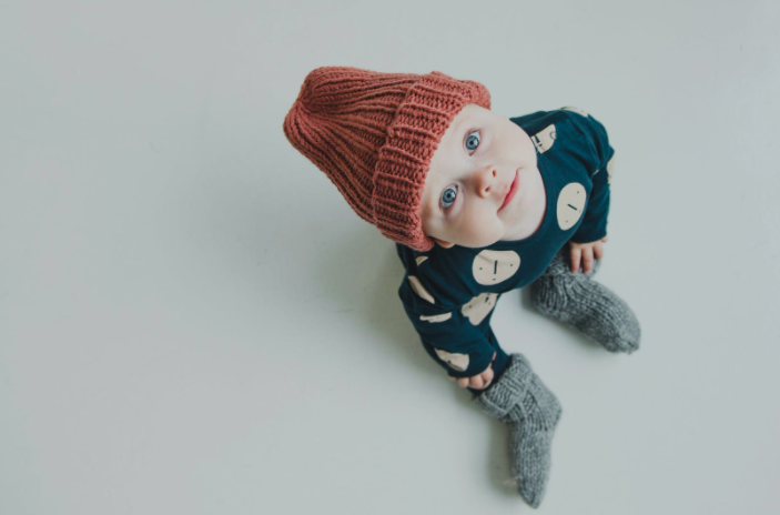 Baby Boy wearing winter dress watching above