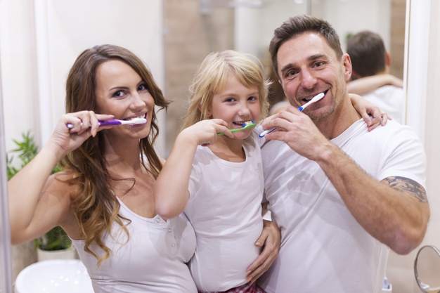 Mother Father and Kid brushing Teeth in morning