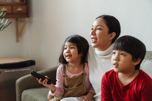 parents and children watching television together